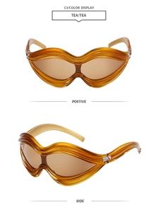 Detail view of tea-colored wave-shaped sunglasses with stylish curved frames and side angle
