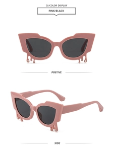 Detail of pink cat-eye sunglasses with teardrop accents and small rhinestones on the frame