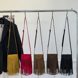 Five assorted matte leather crossbody bags with long fringe tassels in boho style