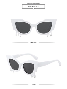 Detail of white cat-eye sunglasses with teardrop accents and rhinestones on the frame