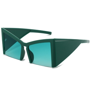 Modern oversized cat-eye sunglasses with thick dark green frames and teal lenses