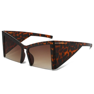Modern oversized geometric cat eye sunglasses with tortoise shell frame and brown gradient lenses