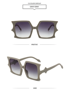 Detail view of grey frosted bat-shape sunglasses with purple gradient lenses