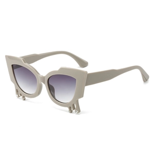 Cat-eye sunglasses in khaki frame with unique drip design and small crystal accents