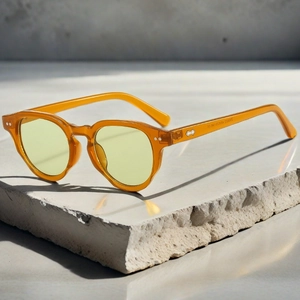 Detail of amber acetate sunglasses frame with engraved SN9233 model specs and CE logo