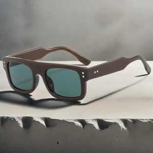 Detail view of square matte brown sunglasses featuring silver diamond rivet accents on frame