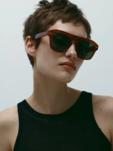 Close-up of retro square tortoiseshell sunglasses with gold rivets on female model