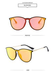 Close-up of black aviator sunglasses with gold metal temples and red gradient mirror lenses