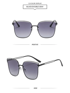 Detail view of black hollow metal frame sunglasses with gray gradient lenses