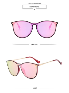 Detail view of large aviator sunglasses with red purple gradient lenses and gold metal frames