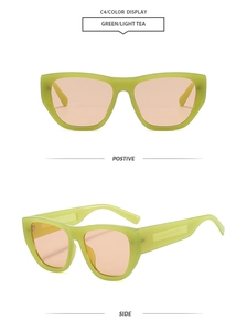 Detail view of green cat eye sunglasses with thick frames and light tea lenses