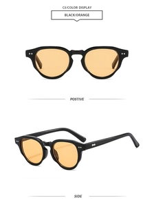 Detail of vintage black round frames with orange lenses and decorative double rivets