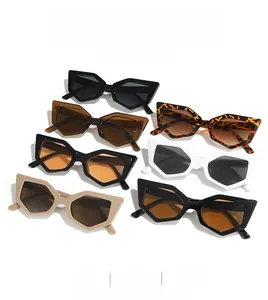 Flat lay of geometric cat eye sunglasses in various colors like leopard and black