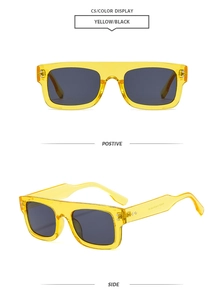 Detail view of square yellow transparent frame sunglasses with metal rivets and grey lenses