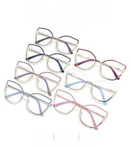 Detail showing various colors of cat-eye frames with pearl accents and metal temples