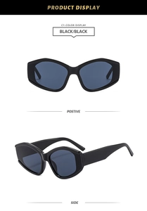 Detail of trendy black cat-eye sunglasses with irregular geometric frames and black lenses