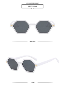 Macro detail of white geometric hexagonal sunglasses with metallic temple accents