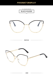 Detail view of cat eye glasses with black golden frames and pearl side accents