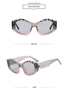 Detail view of cat eye sunglasses with gray pink gradient frames and leopard pattern