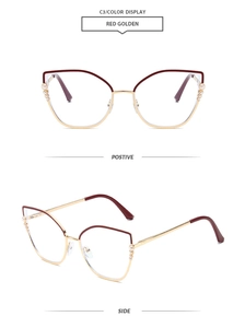 Detail view of red and golden cat-eye frames with elegant pearl side embellishments