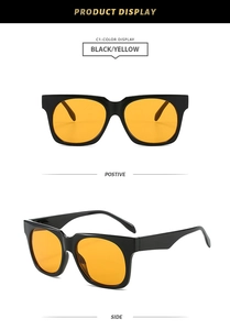 Close-up of black square sunglasses with yellow lenses showing front and side views