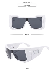 Detail view of white wide-frame sunglasses with grey lenses and side temple relief