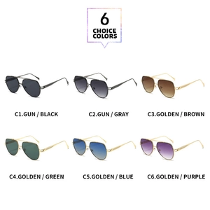 Close-up of classic aviator sunglasses with double-bridge metal frame and wavy textured temples
