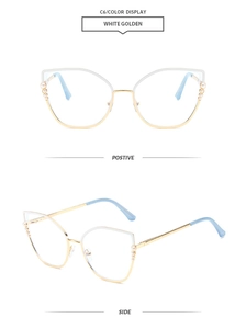 Detail view of cat eye glasses frames with elegant pearl accents and white golden finish