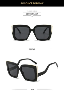 Detail view of square oversized black sunglasses with luxury gold metal hardware accents