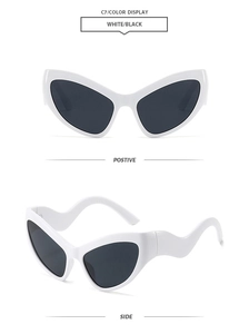 Detail view of white cat-eye sunglasses with unique curved wavy temples and black lenses