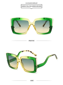 Detail of square oversized sunglasses with green-yellow gradient frames and gold accents