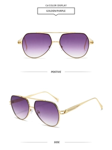 Detail of aviator sunglasses with gold engraved metal frame and purple gradient lenses