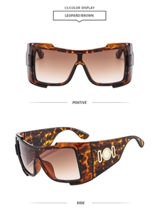 Detail view of leopard print oversized sunglasses with golden metal hinge ornaments