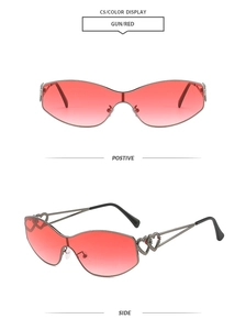 Detail of gunmetal sunglasses frame with red gradient lenses and heart-shaped temple design