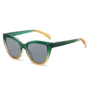 Retro cat eye sunglasses with green and orange gradient frames and dark lenses