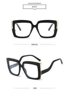 Detail view of square oversized black frame sunglasses with golden metal side accents