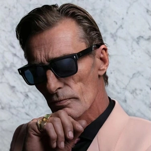 Chic square frame sunglasses with gold studs and chunky rings on a model