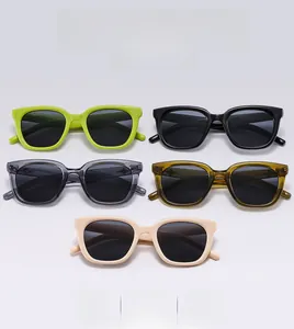 Detailed view of square chunky sunglasses in neon green black and amber colors