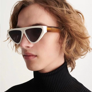 Detail of retro cat-eye sunglasses with ivory frames and tortoiseshell temples
