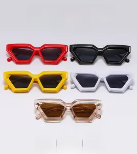 Detail of geometric hexagon sunglasses in red, black, yellow, white, and tea colors