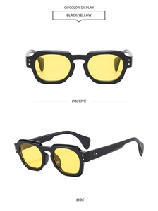 Detail view of vintage chunky sunglasses with black frames, yellow lenses and metal rivets