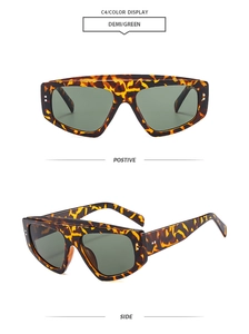 Detail of tortoise frame sunglasses with green lenses and silver side accents