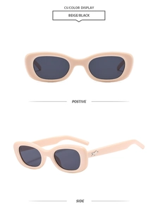 Detail view of oval beige sunglasses with silver star ornaments and dark lenses