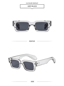 Detail of square vintage sunglasses with grey transparent frame and silver rivet accents