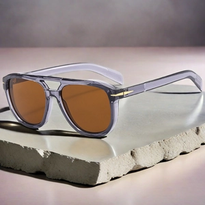 Detail of vintage aviator sunglasses showing golden arrow metal hinges and gradient lenses