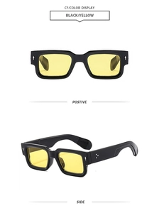 Detail of retro square black frames with yellow lenses and silver arrow rivets
