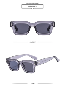 Detail of square vintage sunglasses with translucent grey frame and silver metal accents