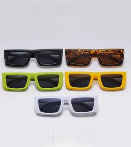 Flat lay of square sunglasses in multiple colors including black, amber, and white