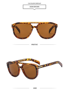 Detail of tortoise pilot sunglasses with double bridge and gold arrow metal accents