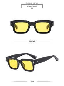 Detail view of square black sunglasses featuring transparent yellow lenses and silver studs